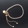 gold bracelet with pink, blue, and gold diamante stones