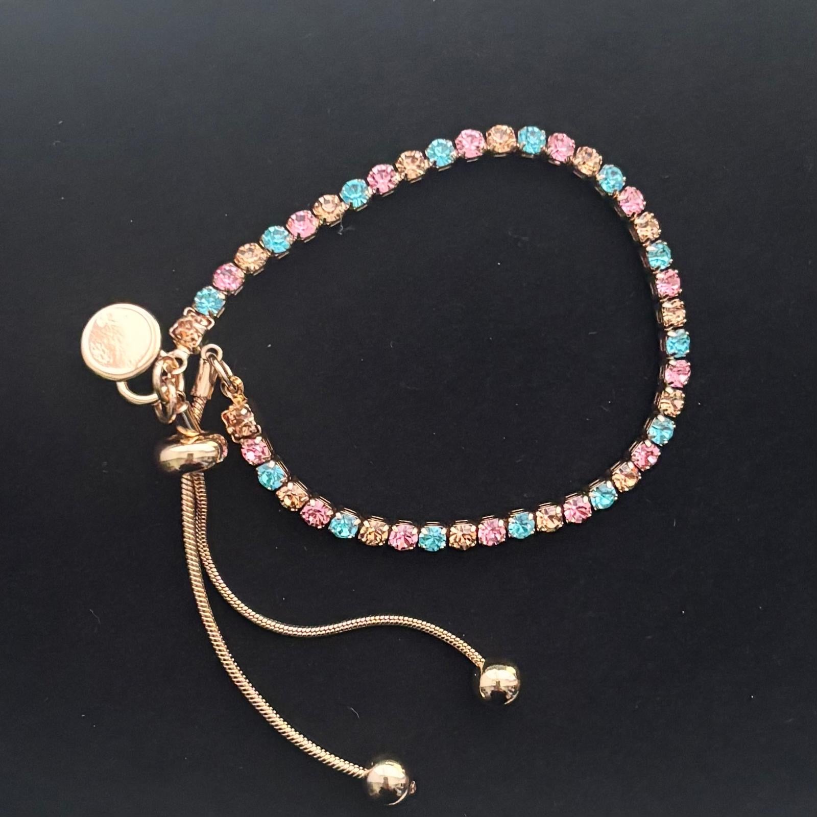 gold bracelet with pink, blue, and gold diamante stones